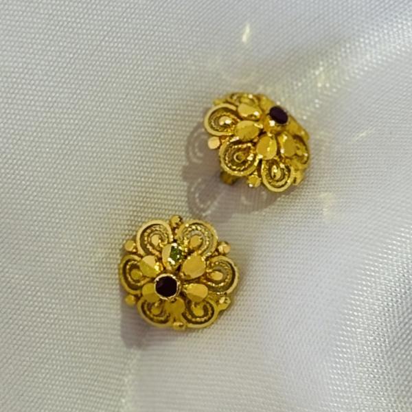 Gold plated flower stud earrings with small red stone for women